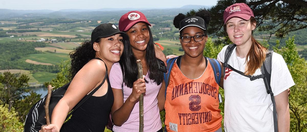 A group of students pose for a photo atop Mt. Mahanoy after the Senior Hike